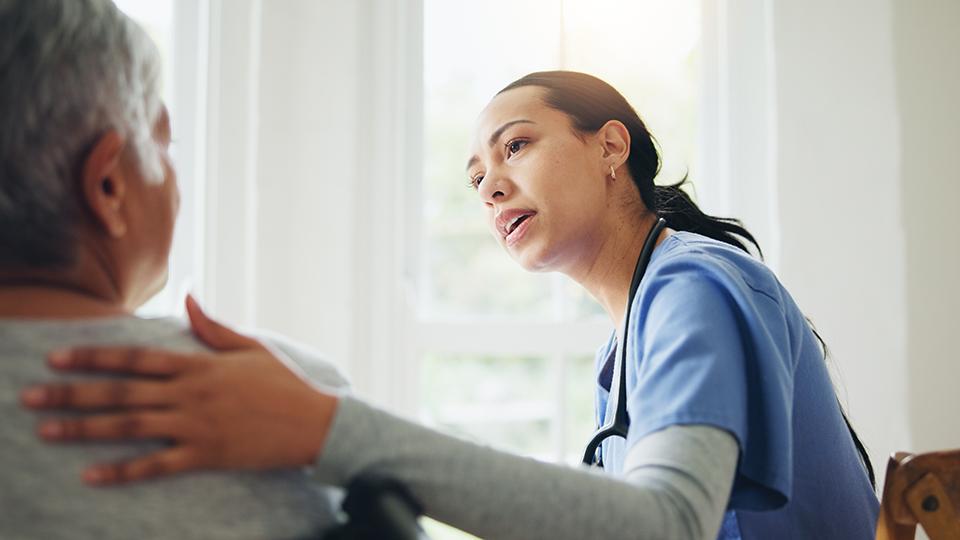 A nurse consults with a patient in a medical setting.